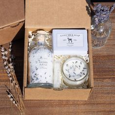 an open box containing lavender and candles