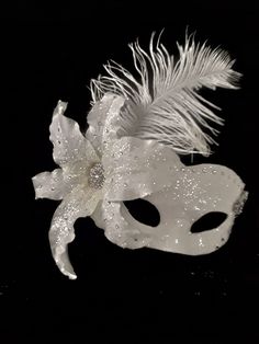 Masquerade Mask , Bridal Mask, Wedding Photo Prop, Ballroom Mask, Mardi Gras, Handmade Mask Handmade one of a kind paper mache mask. Covered with white bridal satin fabric then embellished with clear glitter that adds a sparkle as you walk across the room. I added a large white lilly on right side of mask which is adorned with large crystales and matching glitter. I followed across top of mask with large matching crystals which meet with a large rhinestone brooch in the form of flowers. Tucked b Elegant White Masquerade Mask For Weddings, Elegant White Wedding Masquerade Mask, Elegant Silver Masquerade Mask For Wedding, White Formal Masquerade Mask For Carnival, Traditional White Masquerade Mask For Carnival, Traditional White Bridal Accessories For Party, Ballroom Mask, White Masquerade Mask, Silver Masquerade Mask