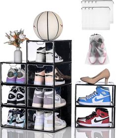 several pairs of shoes and a basketball are on display in front of a white background