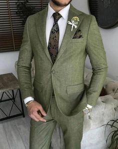 a man wearing a suit and tie standing in a living room