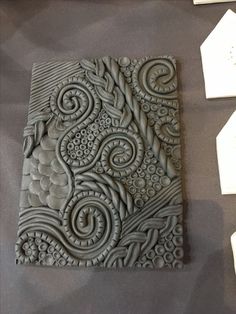 an intricately designed tile is displayed on a table