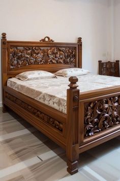 a large wooden bed sitting on top of a hard wood floor