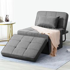 a bed sitting on top of a rug next to a chair