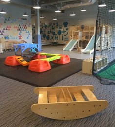 children's play area with slides and climbing equipment in the background at an indoor playground