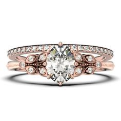 a rose cut diamond ring with two rows of diamonds on the band and an oval shaped center