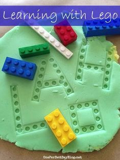 a close up of a cake with legos on it and the words learning with lego