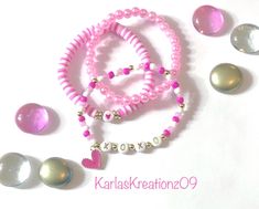 This super cute Valentine's bracelet stack set includes 3 bracelets made of pink, white and gold seed beads, heishi clay beads and pink faux pearl beads. The seed bead bracelet features the phrase "XOXO" in gold lettering on white beads and a pink and gold heart charm. The heishi clay bead bracelet features a white bead with a pink heart. Each bracelet is made with quality beads and stretch cord. Makes a great gift! ❤️Bracelets are handmade to order and ships within 1-2 business days.  ❤️Please Valentine’s Day Beaded Bracelet, Valentines Bracelet Ideas, Valentines Clay Bead Bracelets, Clay Bead Bracelet, Clay Bracelet, Seed Bead Bracelet, Clay Bead