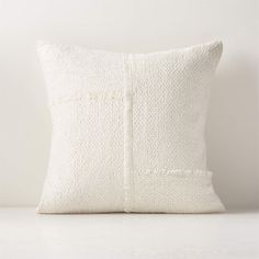 a white pillow sitting on top of a table