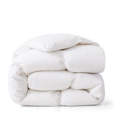 white down comforter stacked on top of each other in front of a white background