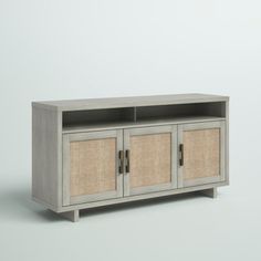 an entertainment center with two wicker doors