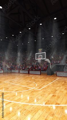 an indoor basketball court with lights and fans in the stands, as well as onlookers