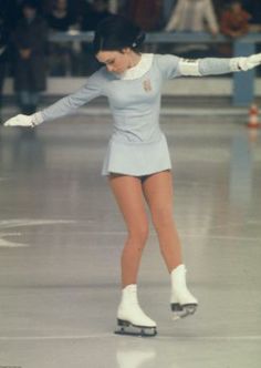 a woman is skating on the ice rink