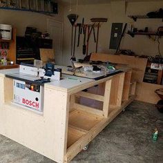 a workbench in a garage with tools on the table and shelves behind it