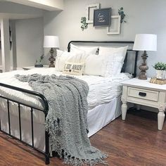 a bed with white sheets and pillows in a room