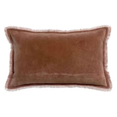 a brown pillow with fringe trim