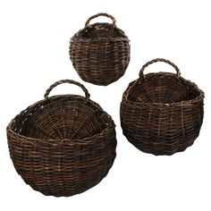 three brown wicker baskets with handles