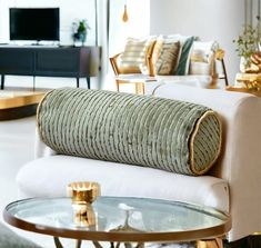 a living room filled with furniture and a glass top table in front of a tv