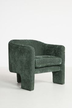 a green chair sitting on top of a white floor