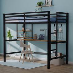 a loft bed with desk underneath it in a room that has blue walls and hardwood floors