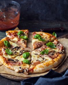 a pizza sitting on top of a wooden cutting board