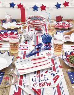 red, white and blue patriotic party supplies on a wooden table with american flag decorations