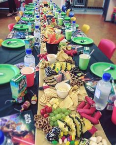 a long table covered in plates and bowls filled with food