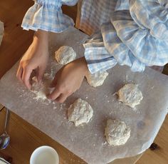 a person is kneading some food on a board