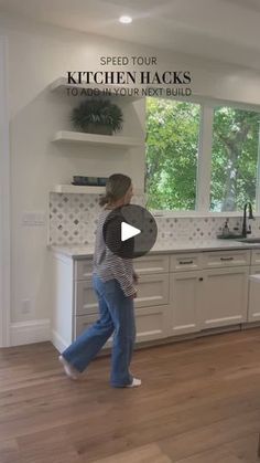 a woman is walking through the kitchen