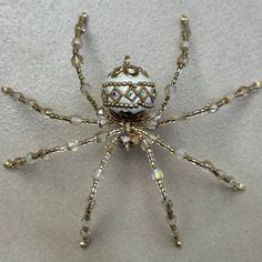 a gold and white beaded spider on a table