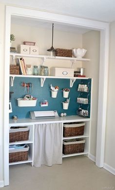 a room that has some shelves and baskets on the wall in front of it,