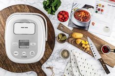 an electric pressure cooker sitting on top of a counter next to other kitchen items