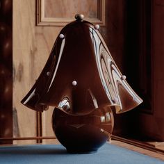 a brown lamp sitting on top of a blue table