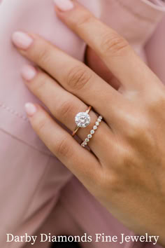 a woman's hand with a diamond ring on top of her finger and the words, darby diamonds fine jewelry