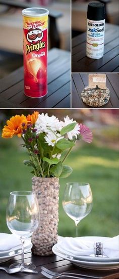 there are flowers in a vase and two empty wine glasses on the table with other items