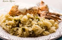 a white plate topped with rice and meat