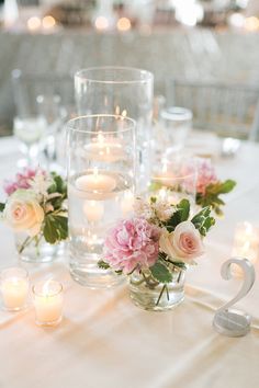 a table with candles and flowers on it