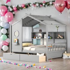 a child's bedroom with pink and white balloons