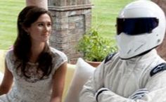 a woman sitting on top of a couch next to a man in a white suit