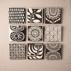 six black and white tiles with designs on them