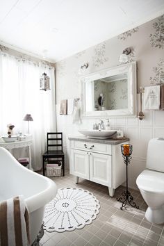 a bathroom with a white toilet, sink and bathtub