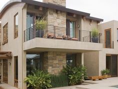 a house with a pool in front of it and plants growing on the outside wall