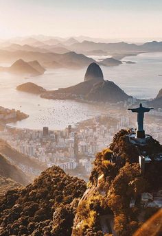 a statue on top of a mountain overlooking the city