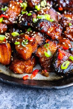 a plate with chicken and sesame seeds on it