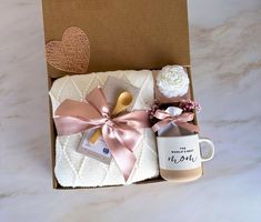 a gift box filled with coffee, marshmallows and other items