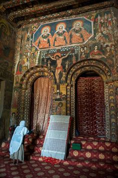 an ornately decorated room with paintings on the walls