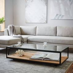 a living room scene with focus on the couch and coffee table in front of it