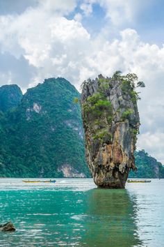 an island in the middle of water surrounded by mountains