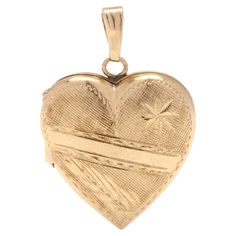 This exquisite 14K yellow gold locket pendant is the perfect way to express your love. Intricately engraved with a heart design, this small gold locket measures 7/8 inch in length. The simple, elegant style of this small gold locket makes it an ideal gift for any special occasion. With its timeless design, this gold heart locket is sure to become a cherished keepsake. Length: 7/8 in. Width: 1/2 in. Weight: 1.1 dwts. / 1.7 grams Stamps: 14K Ring Sizings & Modifications: *Please reach out before y Gold Heart Locket, Heart Pin, Gold Locket, Gold Engraving, Heart Locket, Simple Elegant, Gold Heart, Heart Of Gold, Heart Design