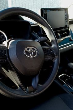 the interior of a car with steering wheel, dashboard and touch screen monitor on display