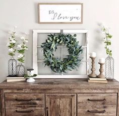 an old dresser has a wreath on top